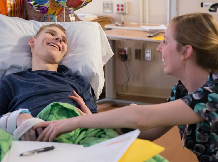 Matthew, Gillette children's patient with nurse in hospital room