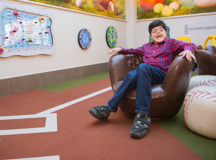 Gillette patient Michael in playroom at St. Paul campus.