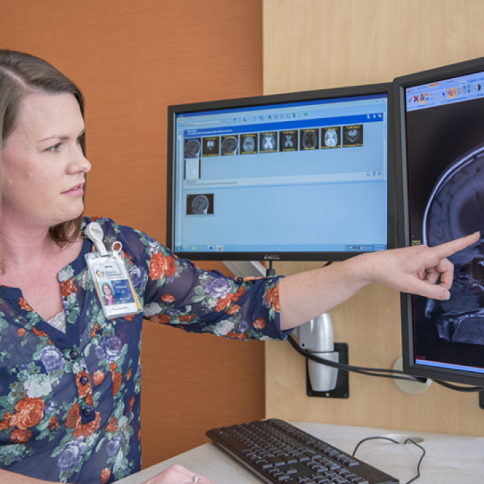 Amanda Seely PMP examines test results at gillette children's specialty healthcare