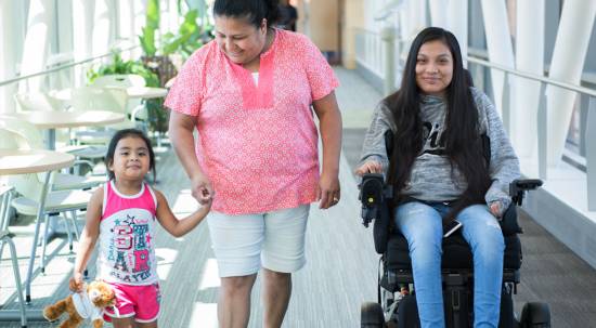 Gillette Children's spinal cord injury patient Guadalupe with her family in skyway