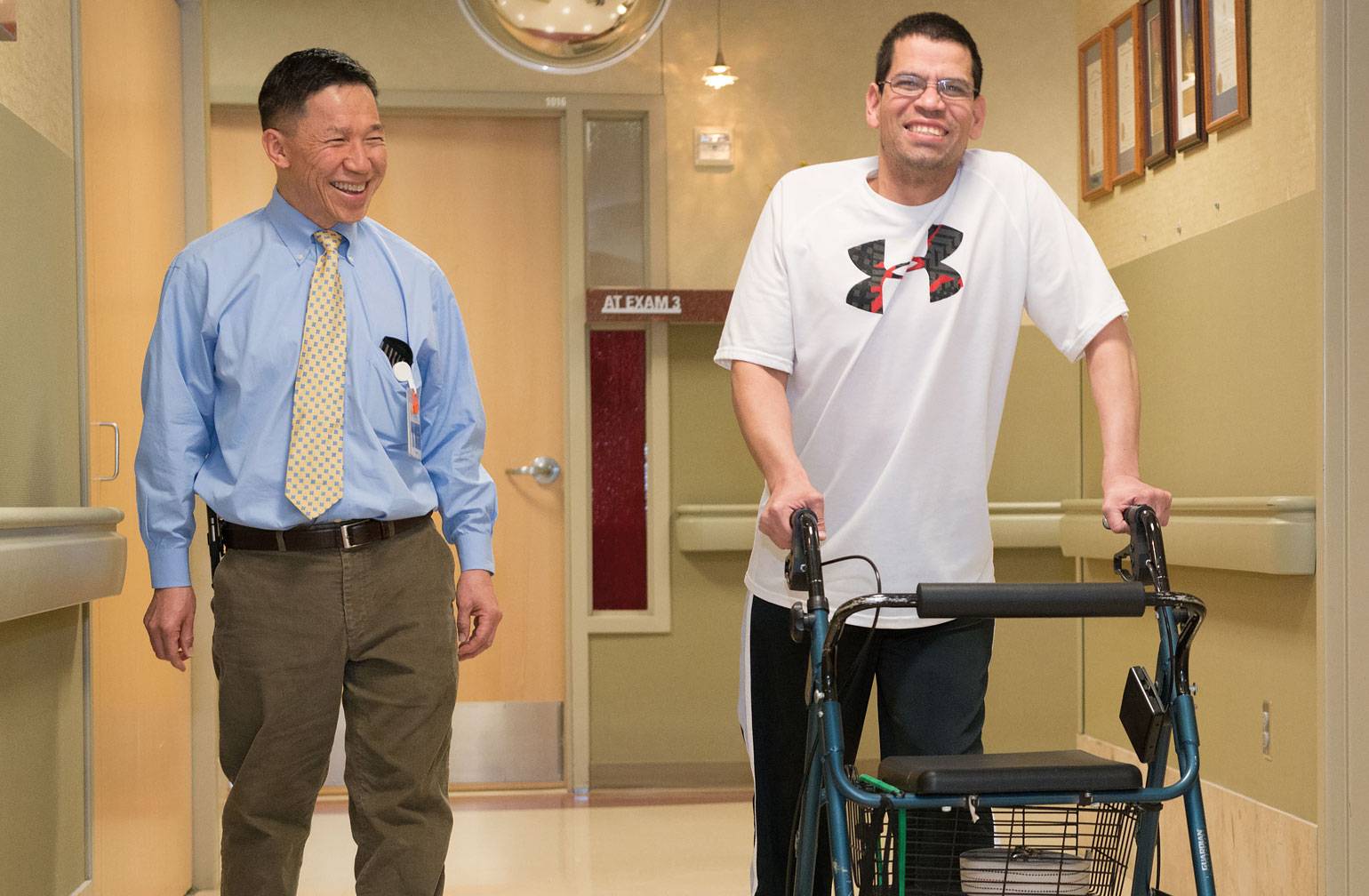 Lee Schuh, MD, walks down hallway with patient at Gillette children's specialty healthcare