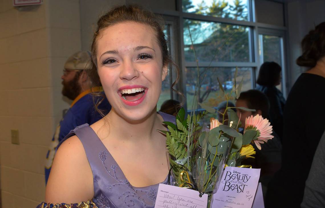 Gillette patient Eliza holding flowers after her performance