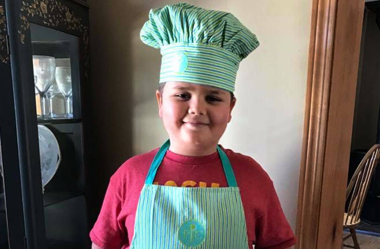 Gillette OI patient, Caleb, in a chef's hat