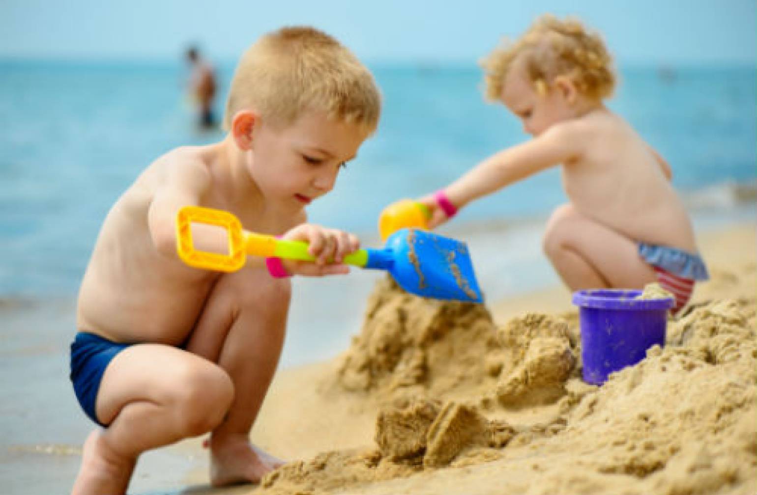 Two little kids playing on the beach
