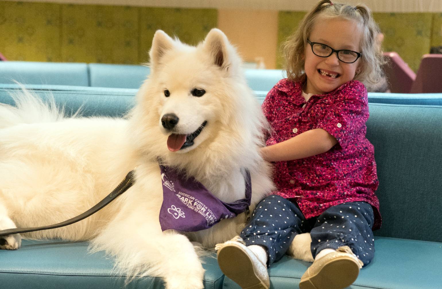 Gillette patient Kaidyn with therapy dog at Gillette.