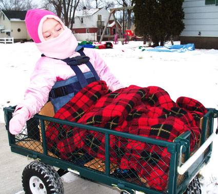 Christina Kademan, who has cerebral palsy, loves wagon rides with her dad, Derek Kademan.